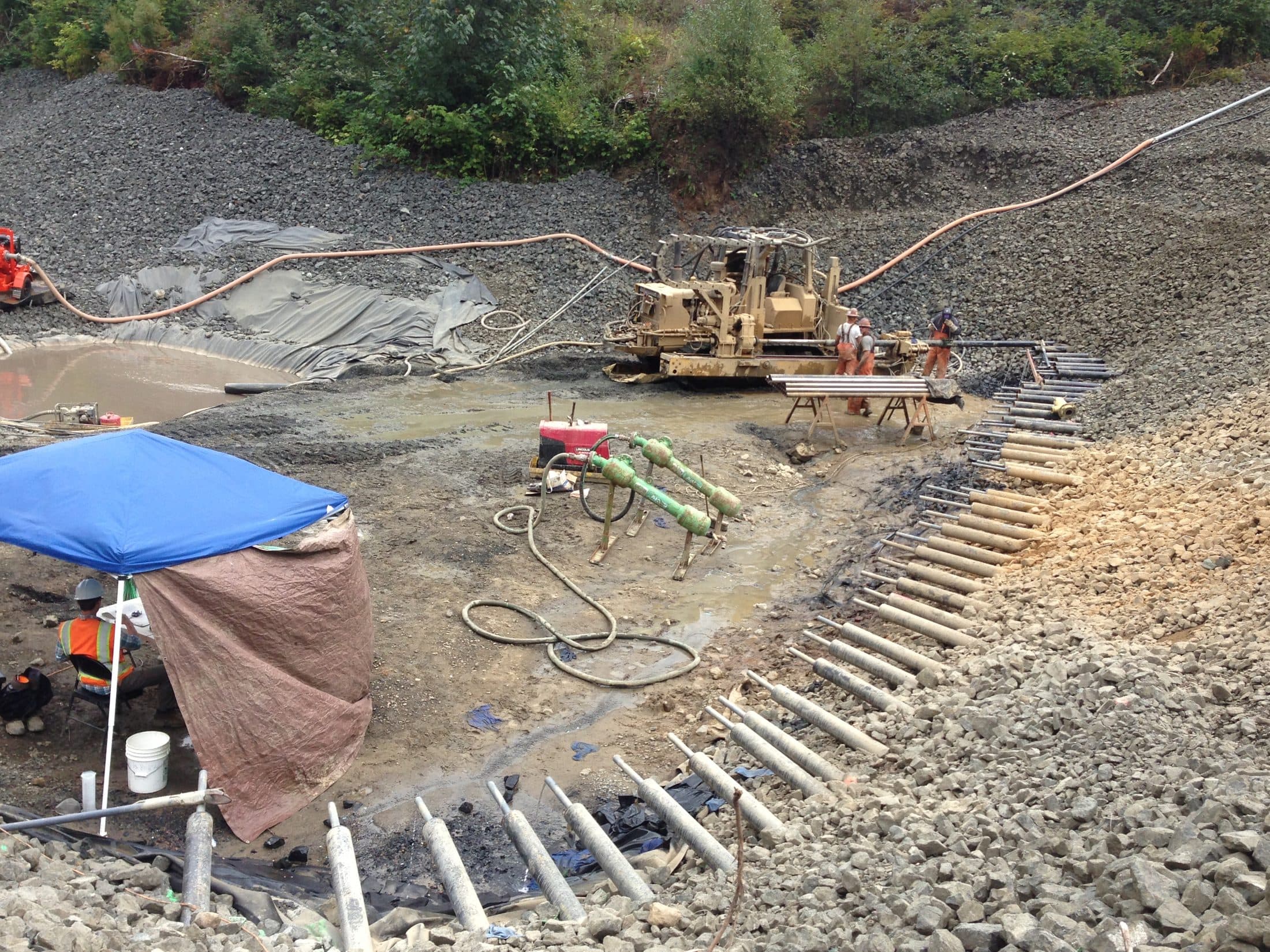 Aerial view of an extensive horizontal drain array across a slope on US101